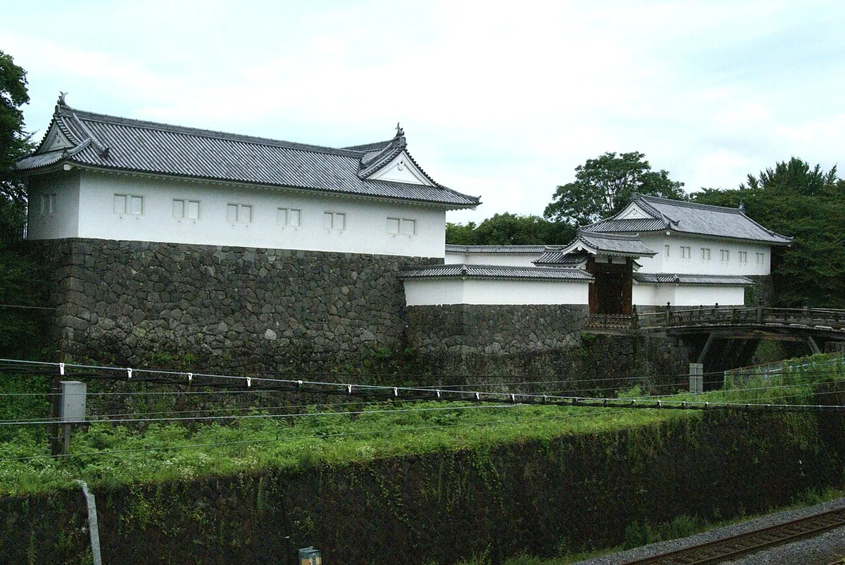 Stone walls, a gate and turrets along the moat of Yamagata Castle