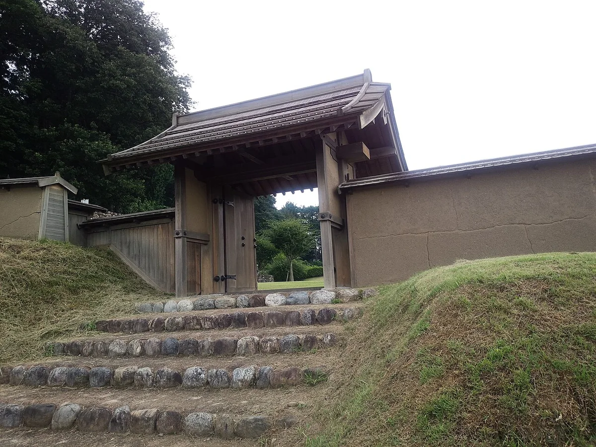 A reconstructed gate above stone steps at Hachigata Castle