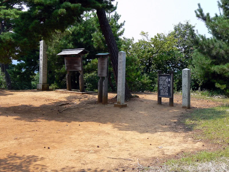 A hilltop clearing and stone markers at Kasugayama Castle