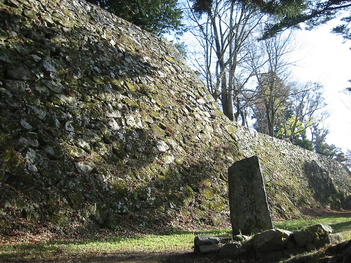 High stone walls and trees at Takatori Castle