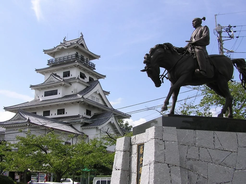 Imabari Castle’s modern keep and an equestrian statue of Todo Takatora
