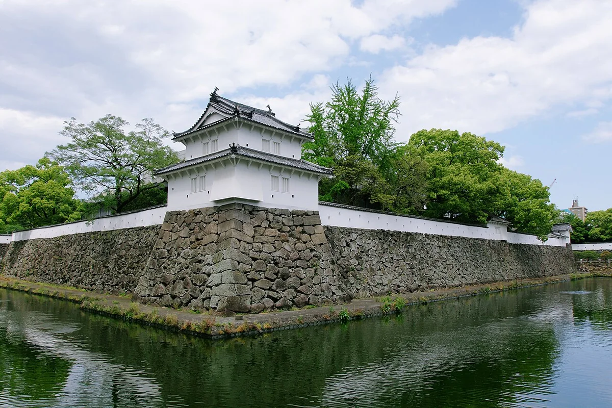 The moat, a turret and stone walls at Oita-Funai Castle