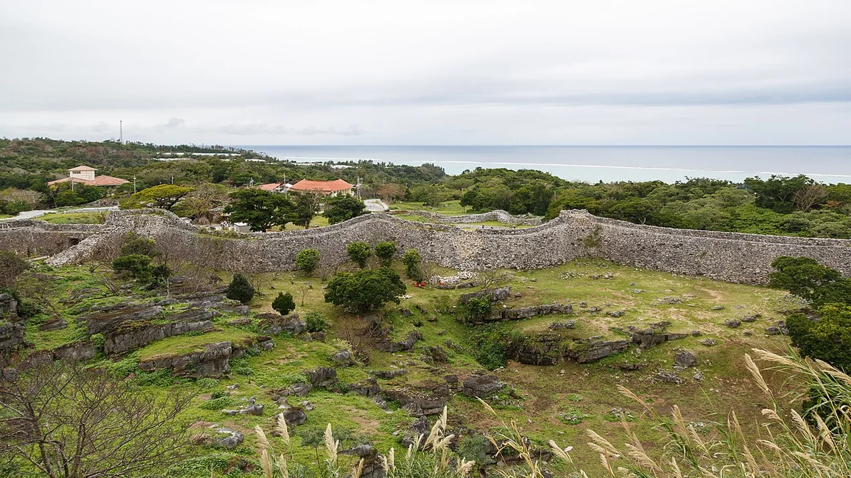Enclosures bounded by stone walls at Nakijin Castle, with the sea beyond